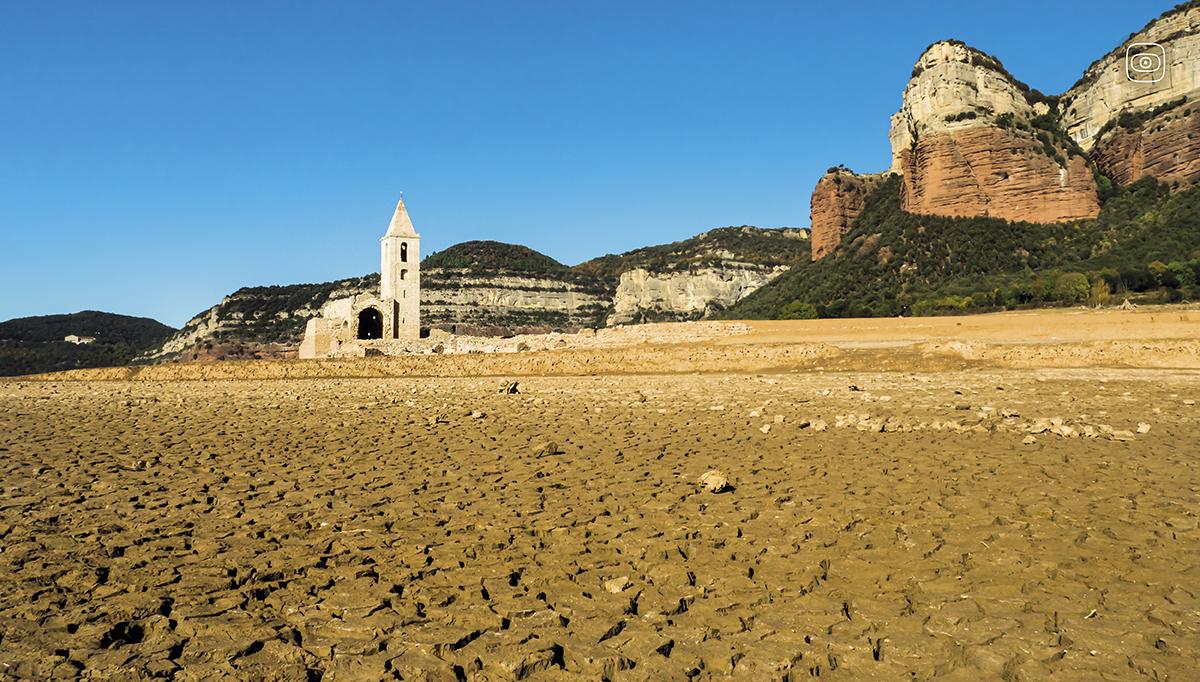 Sau Reservoir in Catalonia, now empty. Dry landscape, blue skies