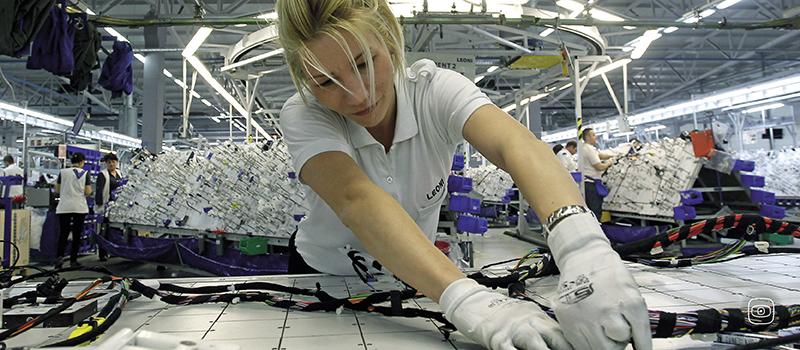 Worker in Leoni factory in Serbia, producing car cables