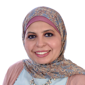 A smiling woman with a headscarf with a flowered pattern